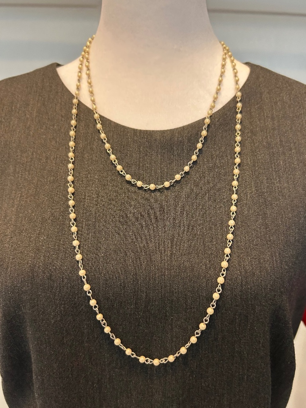 Long gold toned beaded necklace